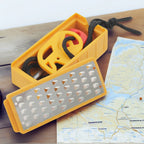 Portable stainless steel tinder maker and fire starter tool for outdoor survival use.
