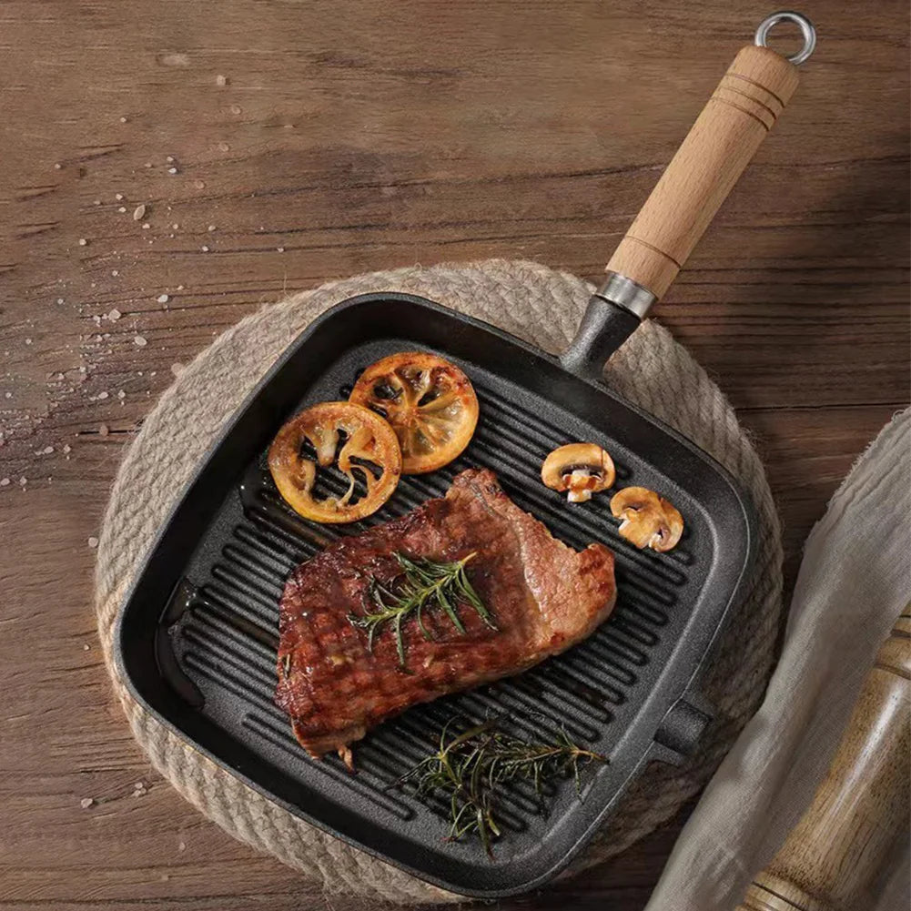Cast iron skillet steak pan with wooden handle, uncoated and ideal for camping cooking